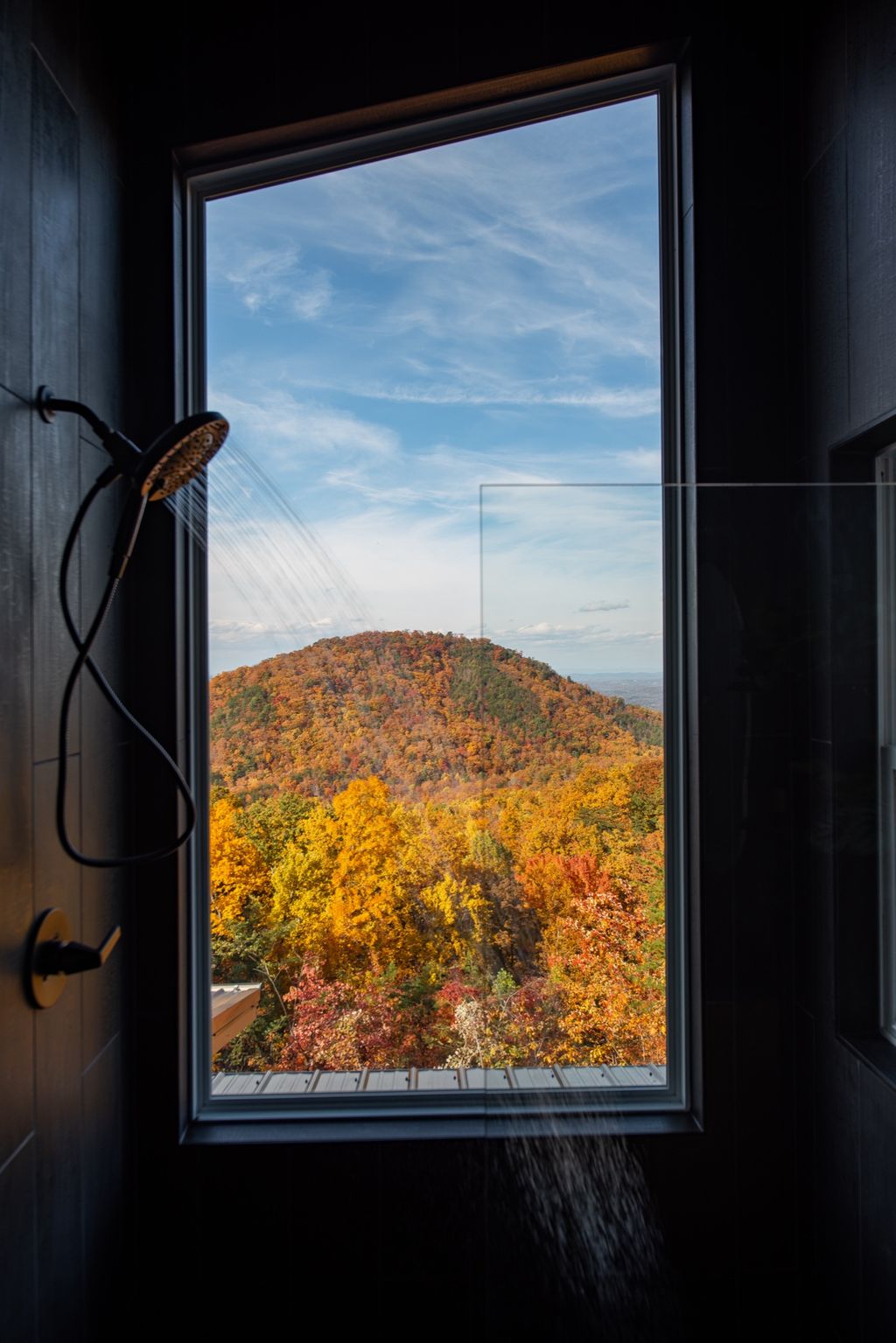 Shower with a window framing the mountain