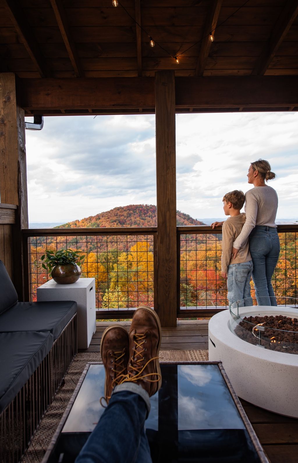 Family taking in the view from the deck by the fire table